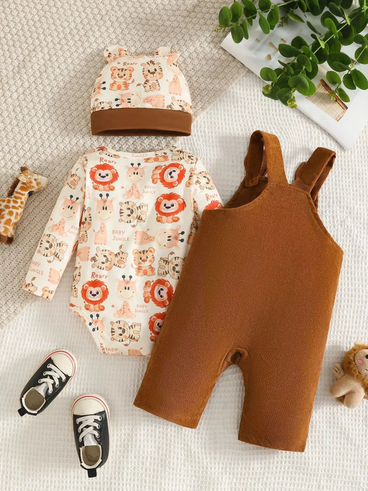 Brown corduroy overalls, animal-print long-sleeve top and matching hat displayed flat