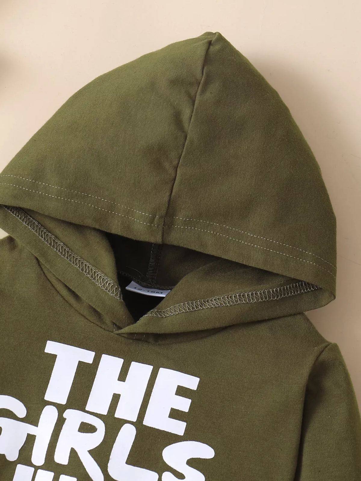 Olive hood and upper chest of the children’s graphic hoodie
