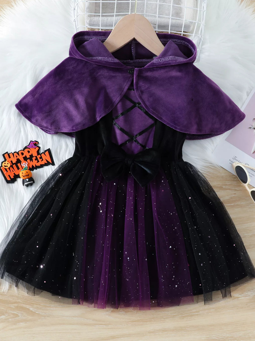 Front view of the purple hooded cape over the black-and-purple Halloween dress.