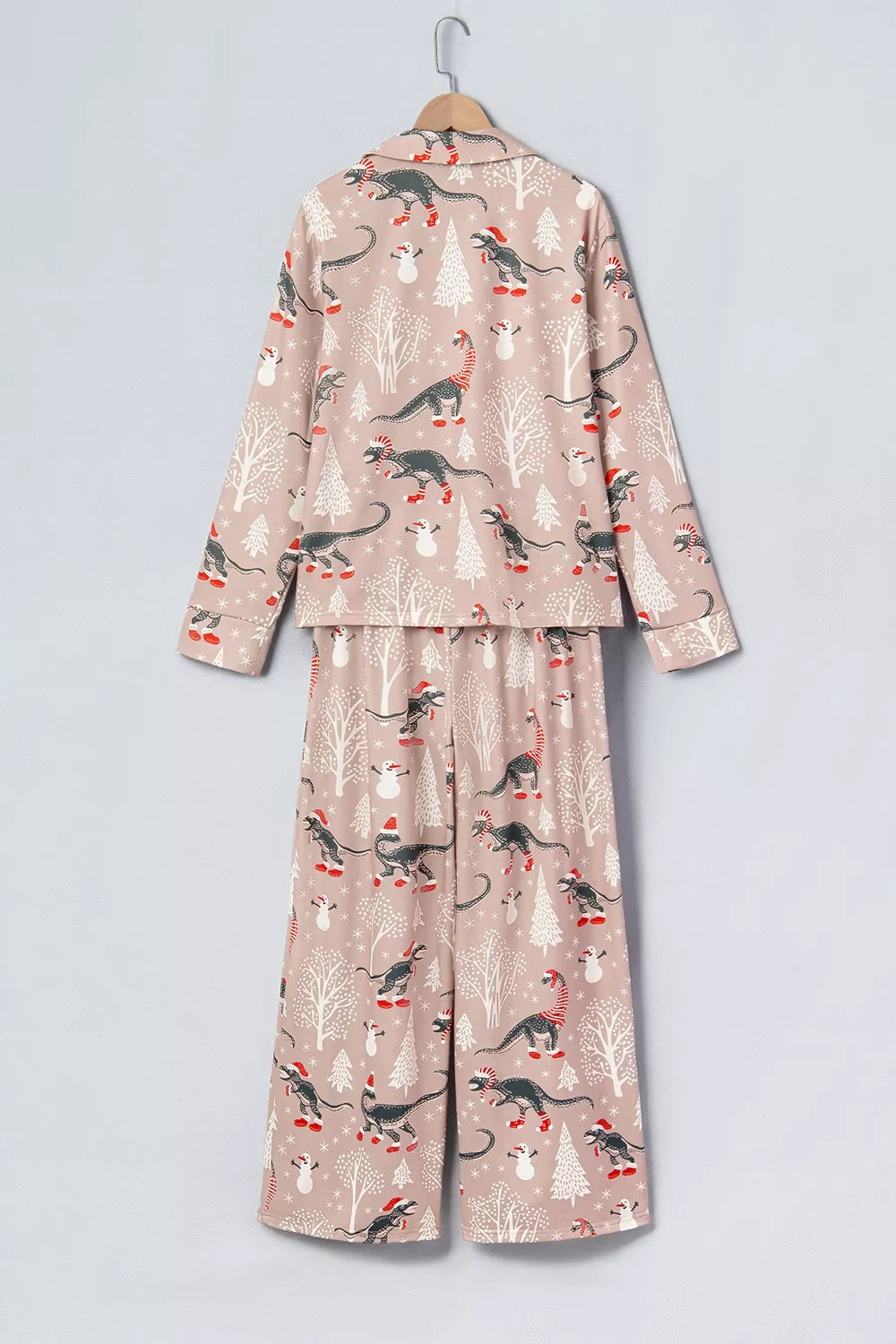 Pink long-sleeve pajama shirt and pants with dinosaur Christmas print — back view