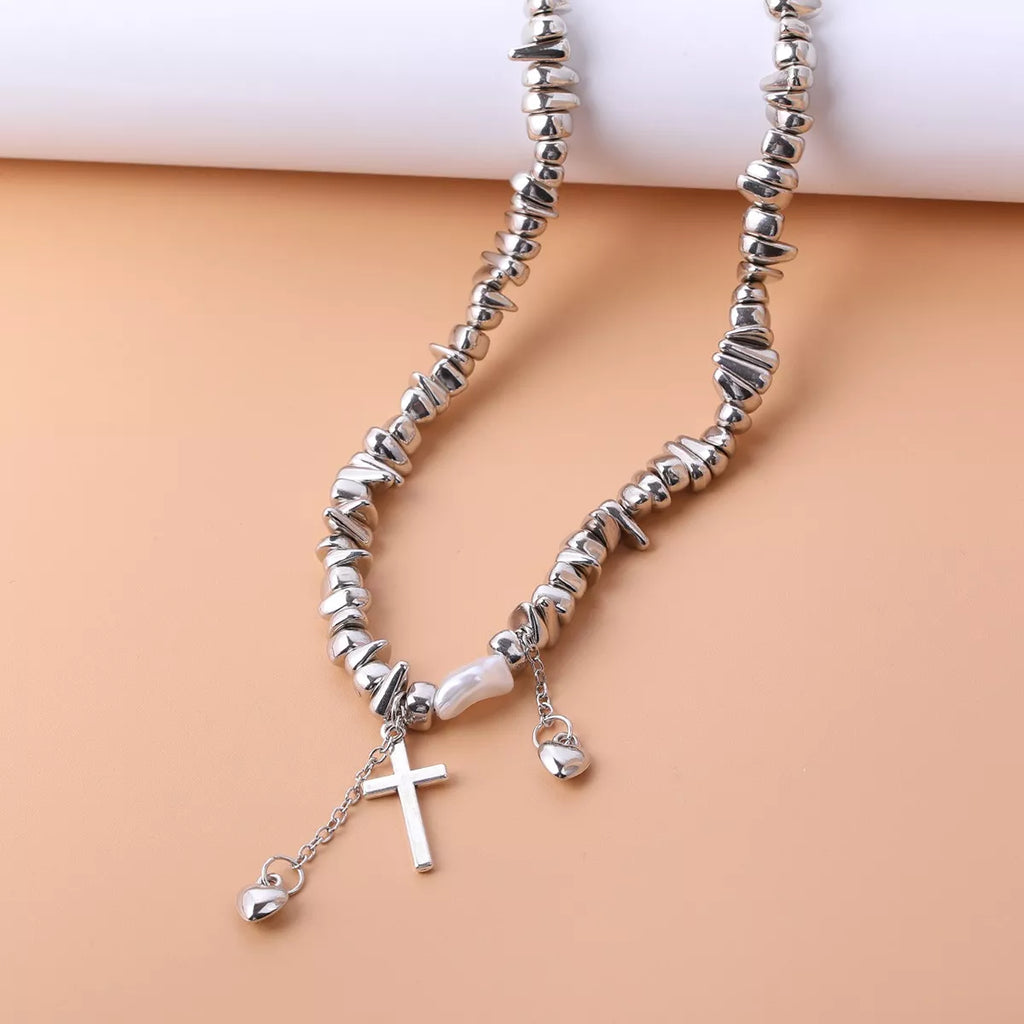 Chunky silver-tone chain necklace with cross and dangling charms — detail view