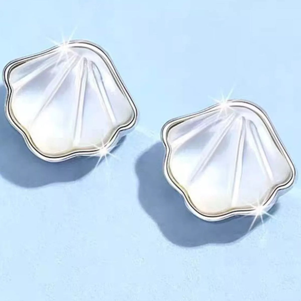 Silver-tone shell-shaped stud earrings with white centers — detail view