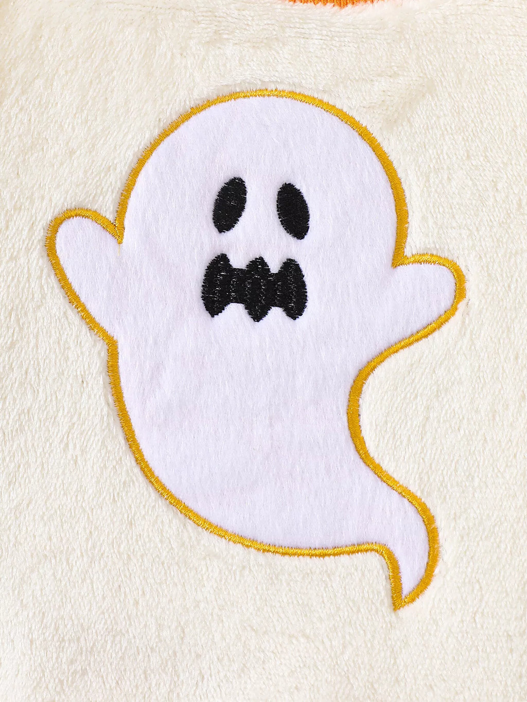 White smiling ghost patch outlined in yellow on the cream top