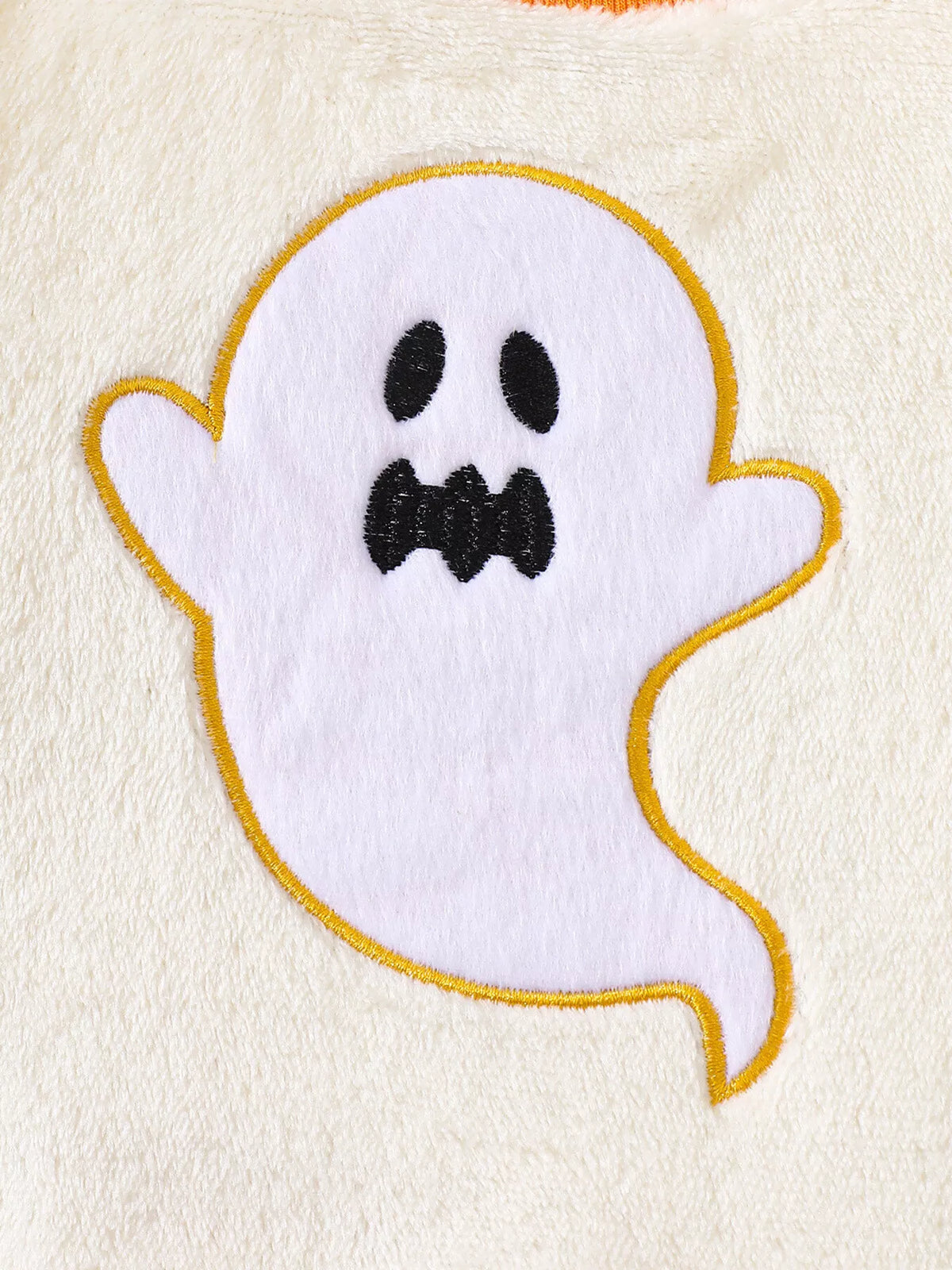 White smiling ghost patch outlined in yellow on the cream top
