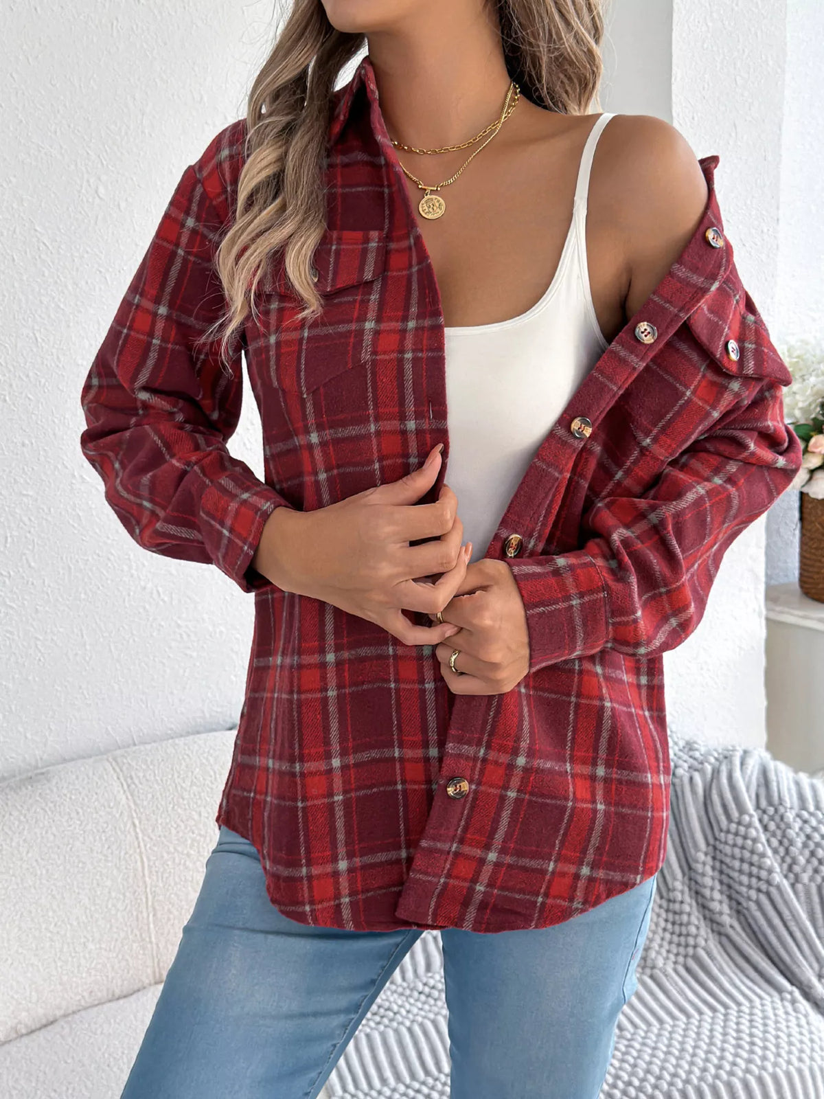 Red plaid button-down shacket with chest pockets, worn open over a white top.