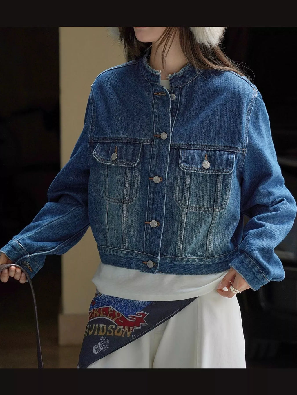 Front view of the blue button-up cropped denim jacket.