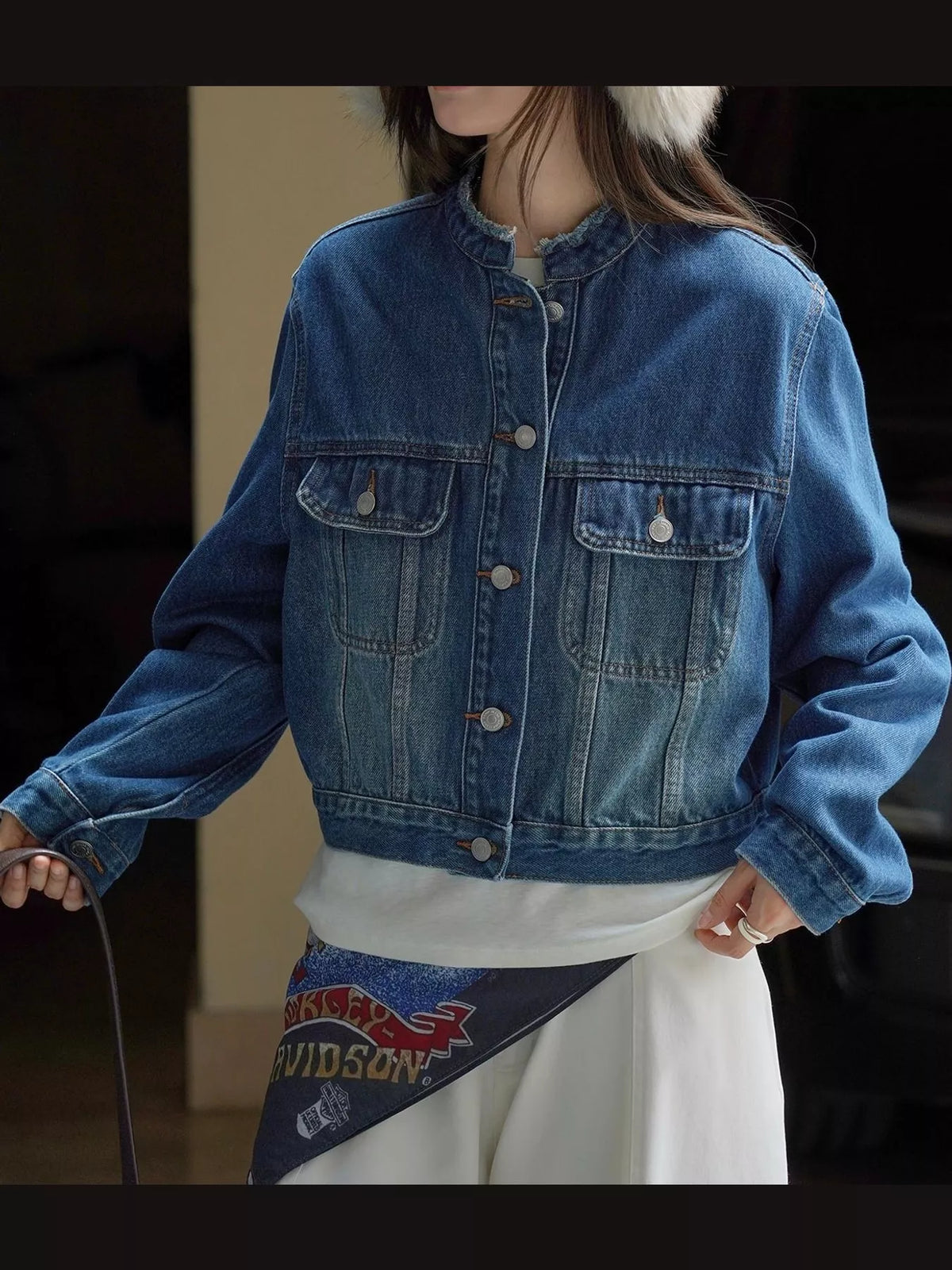 Front view of the blue button-up cropped denim jacket.