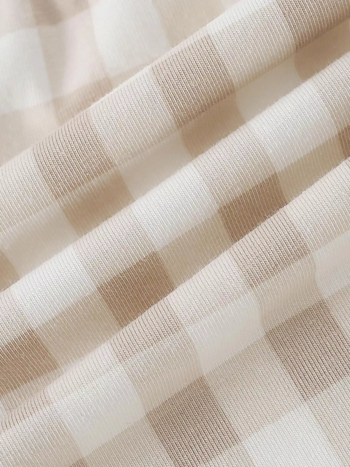 Beige and cream plaid fabric on the children’s pants