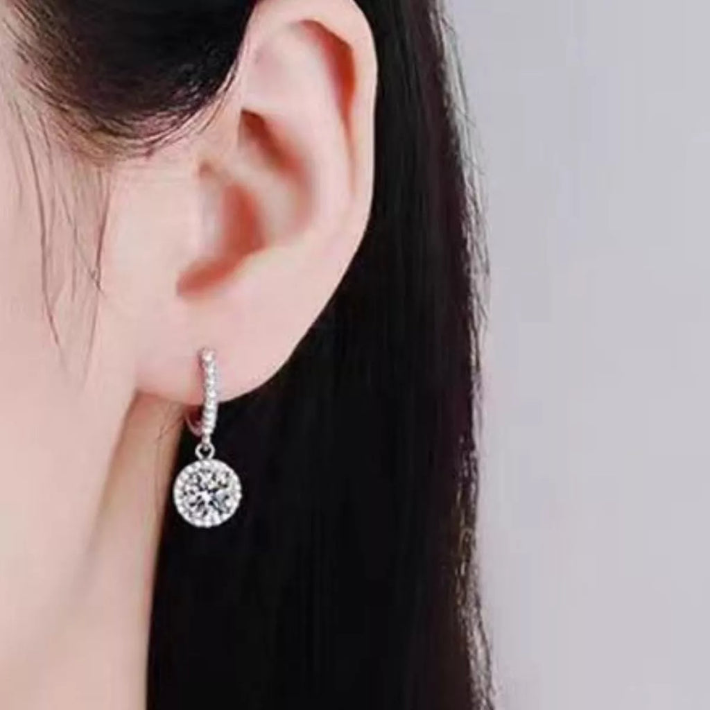 Silver-tone hoop earrings with round halo stone drops — detail view