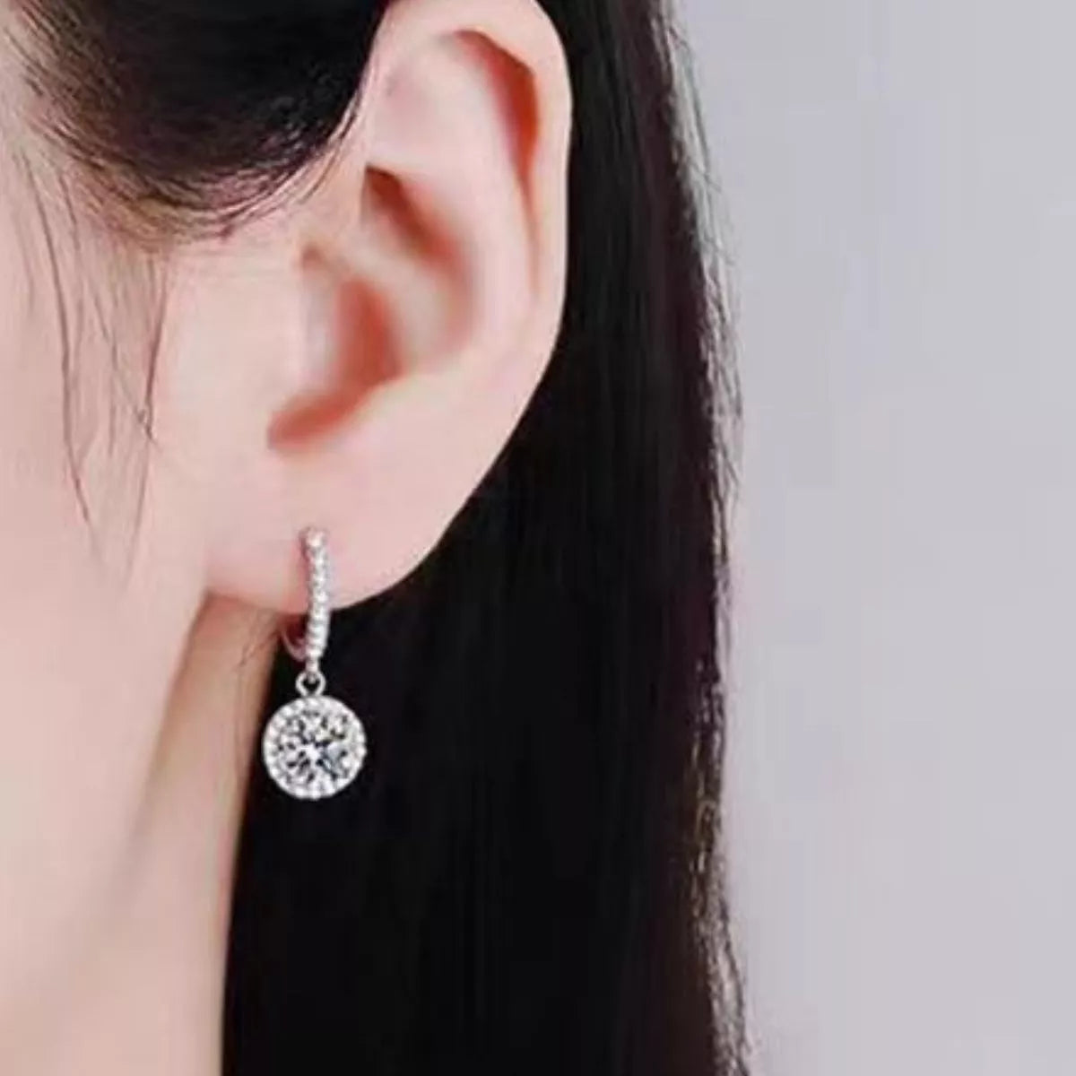 Silver-tone hoop earrings with round halo stone drops — detail view