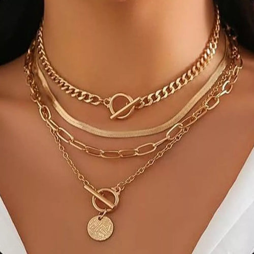 Four layered gold-tone necklaces with coin pendant and mixed chain styles — detail view