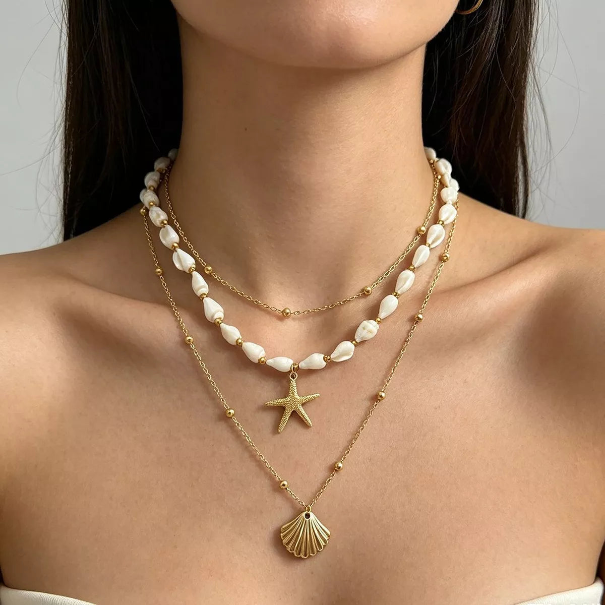 Layered gold-tone shell and starfish charm necklace