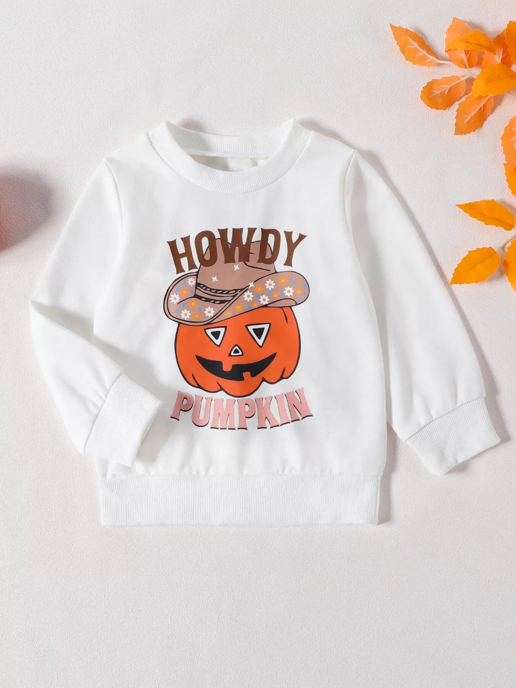 Front view of the white long-sleeve Howdy Pumpkin graphic top.