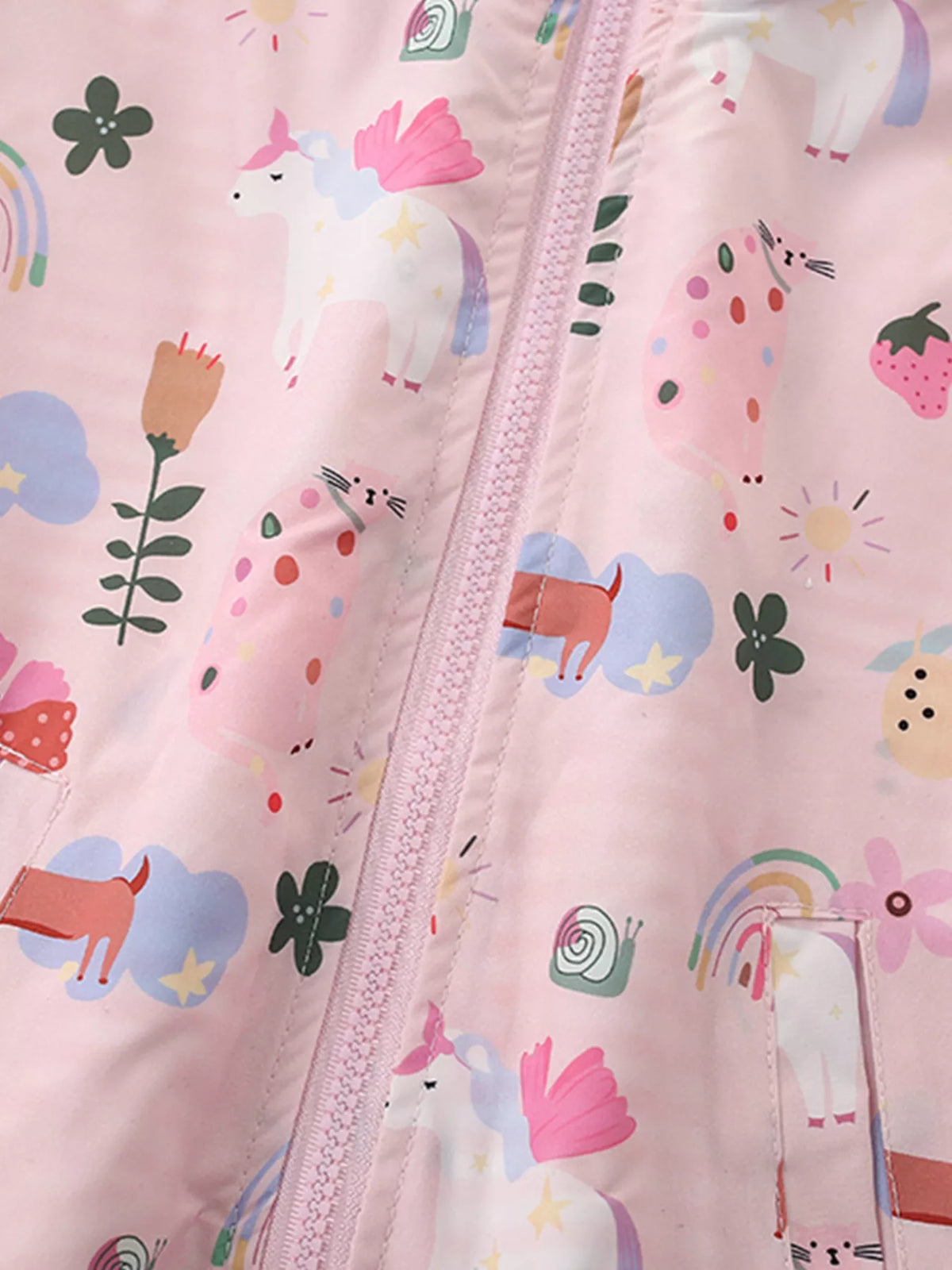 Close-up of the colorful print, zipper and pocket on the pink hooded jacket.