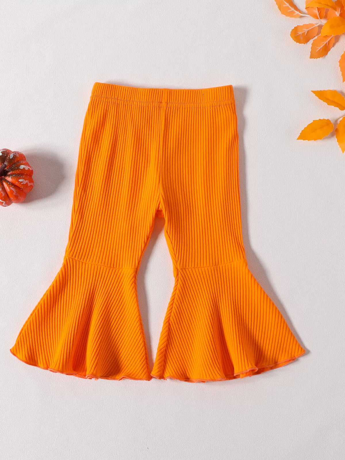 Front view of the orange children's ribbed flared pants.
