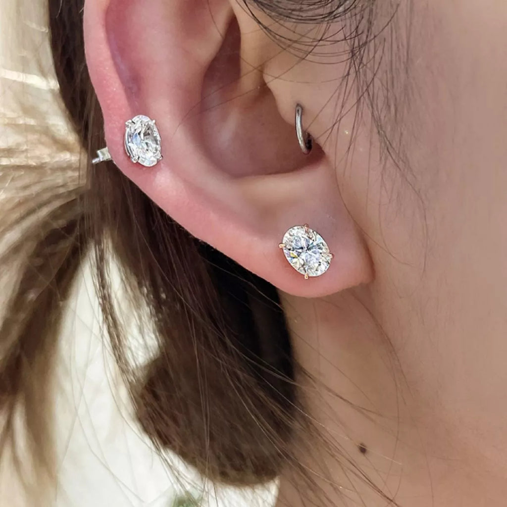 Silver-tone stud earrings with clear faceted stones — detail view