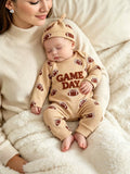 Children’s beige football-print Game Day jumpsuit and matching hat worn by a child