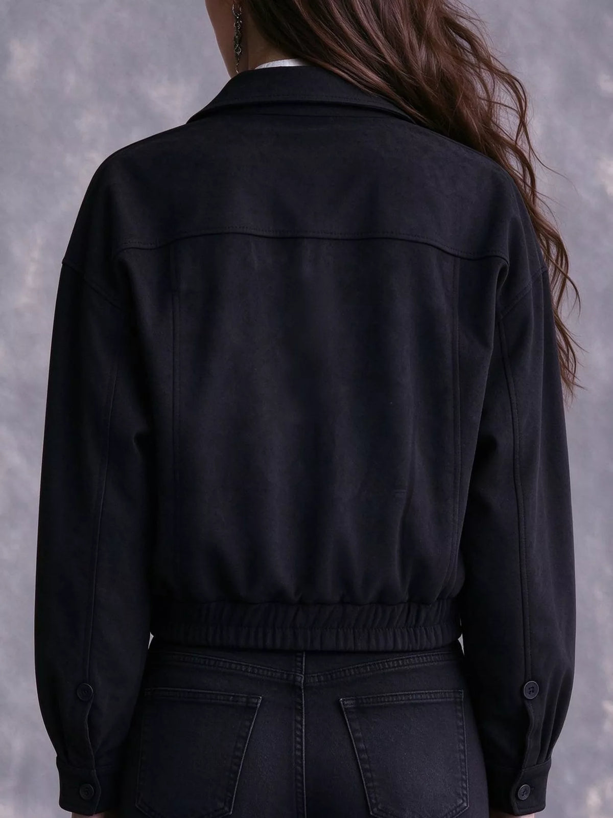 Back view of the black bomber jacket.