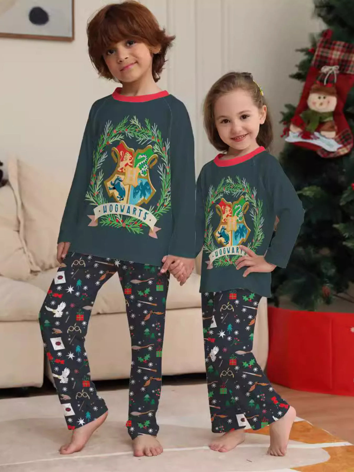 Dark green Hogwarts graphic pajama top with black patterned pants worn by two children