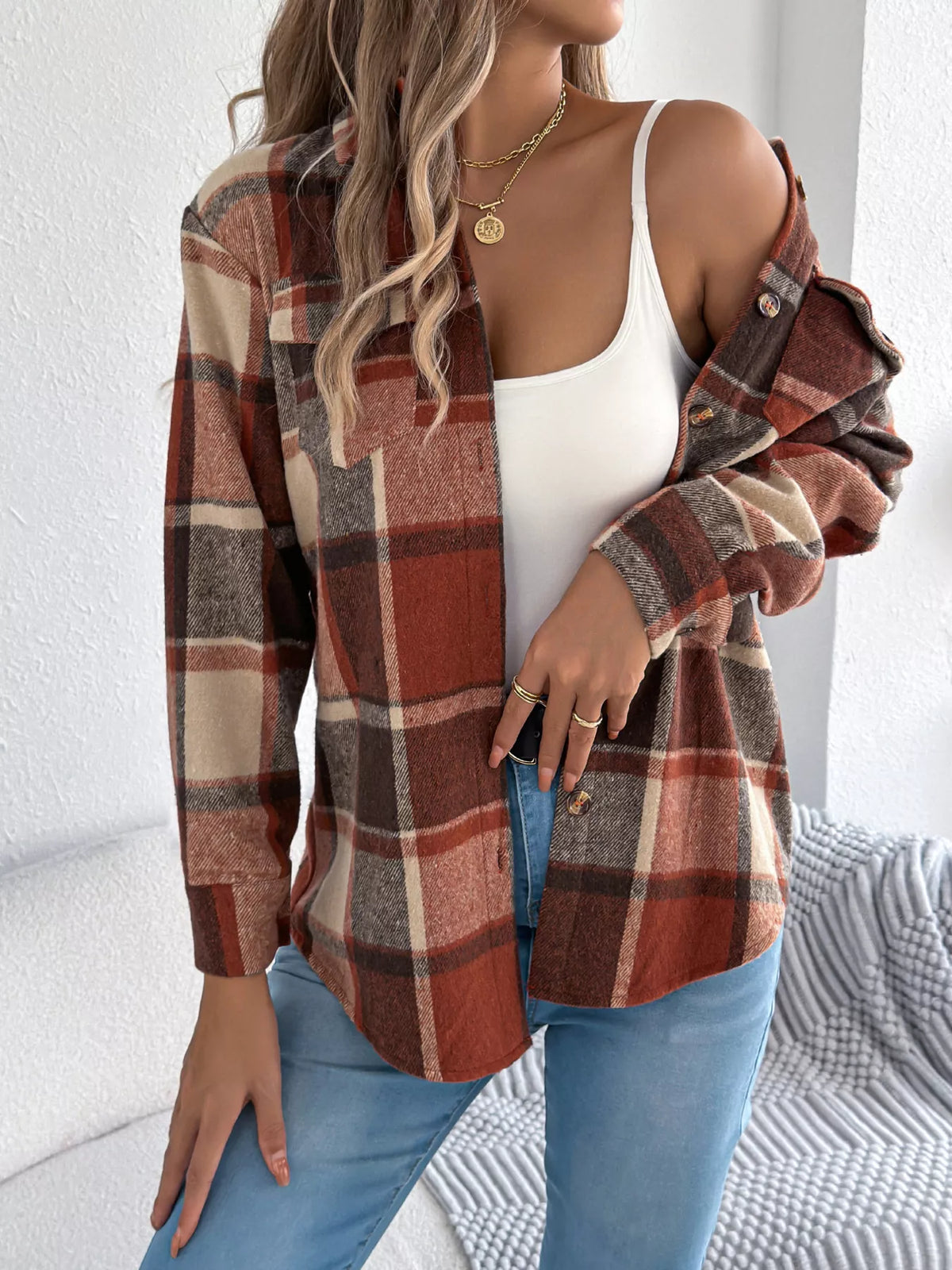 Orange plaid button-down shacket with chest pockets, worn open over a white top.