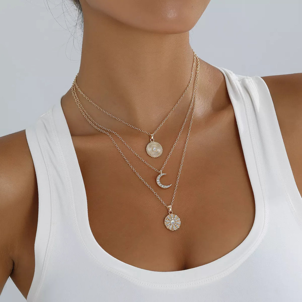 Layered gold-tone moon and coin pendant necklace
