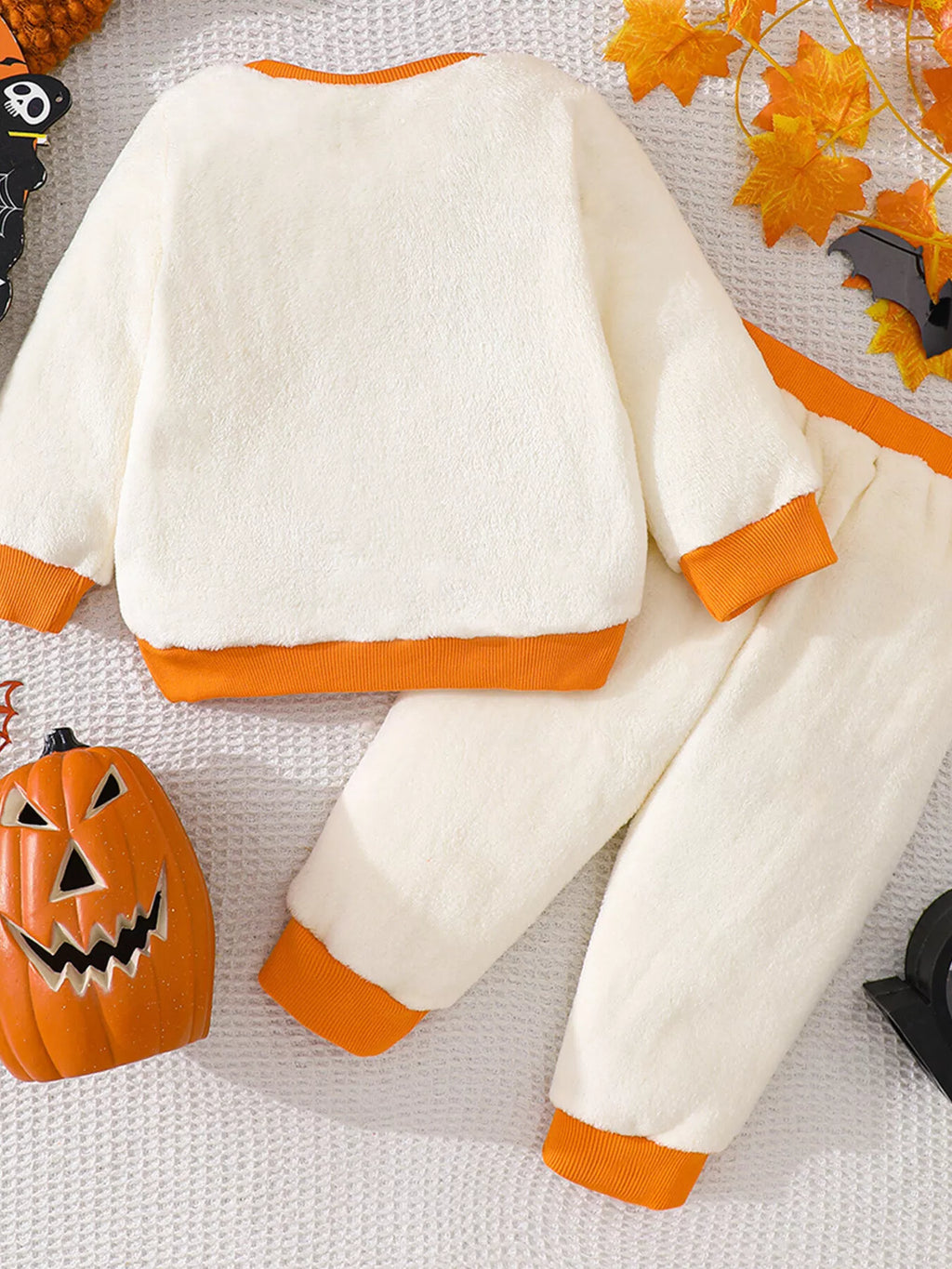 Back of the cream top and matching pants with orange trim