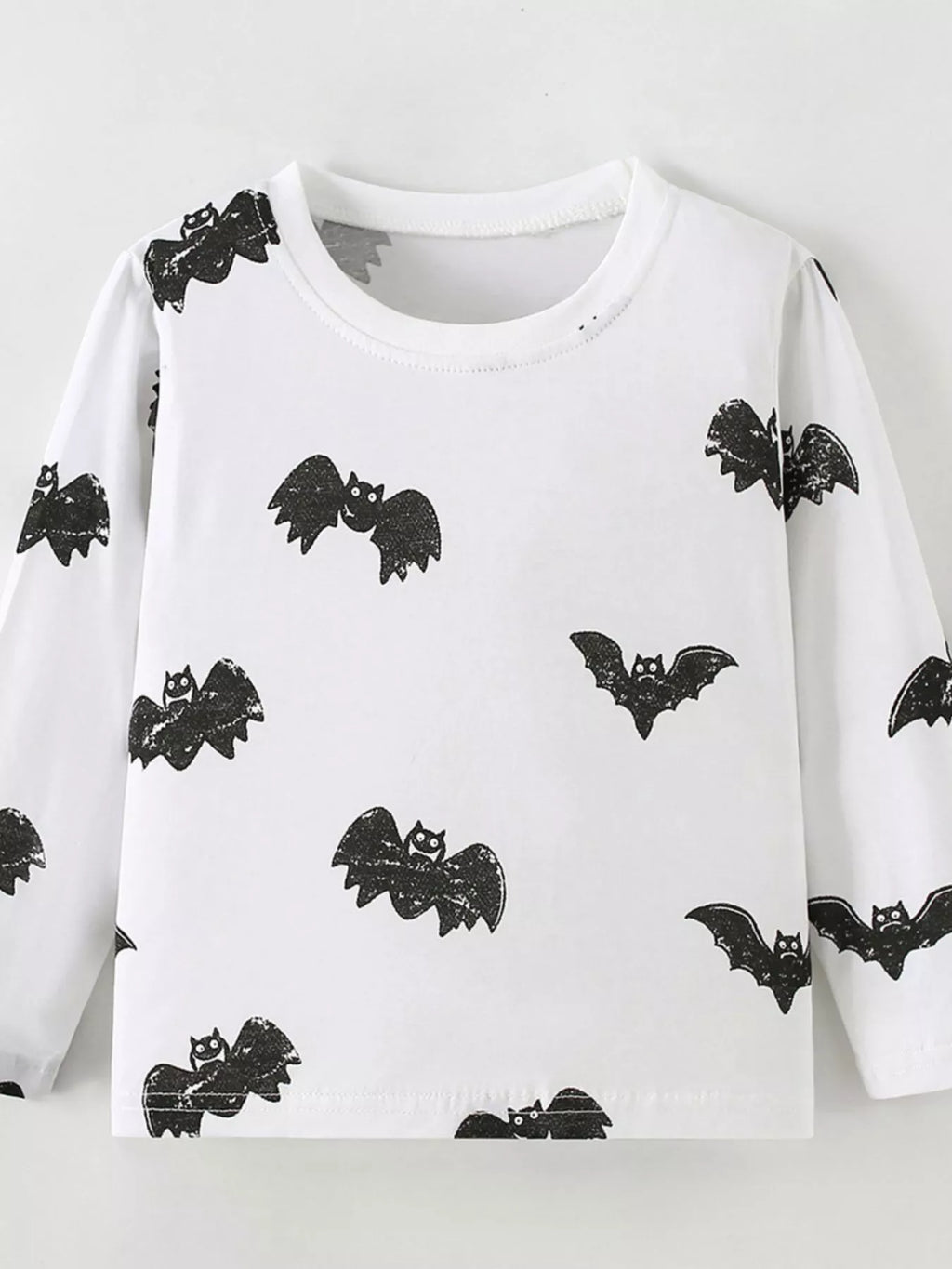 Front product view of the white children's black-bat-print top.
