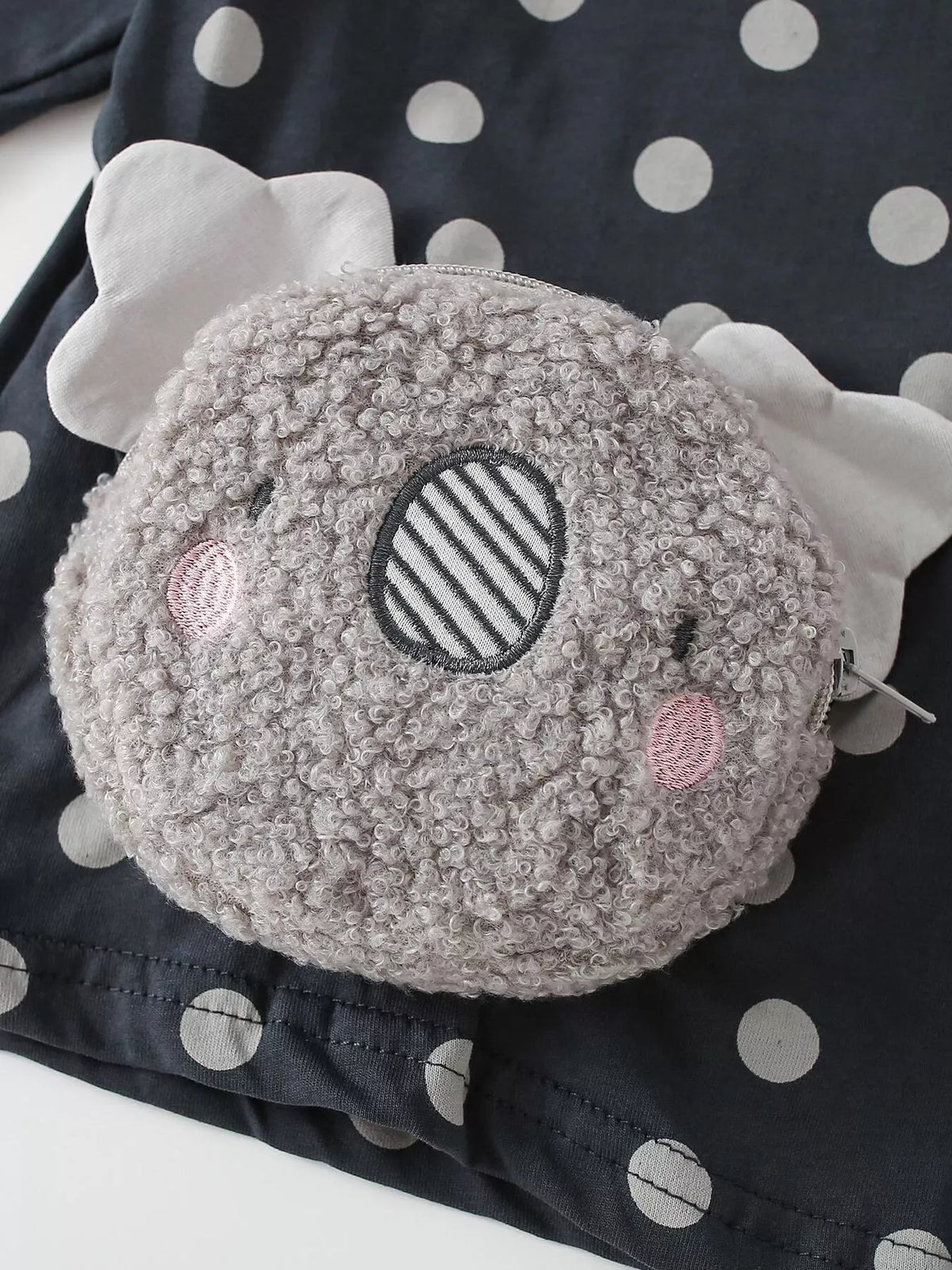 Close-up of the textured gray koala applique with pink cheeks.