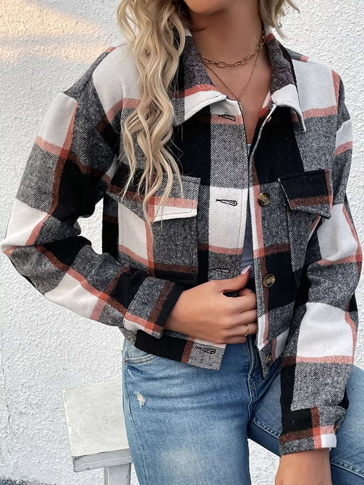 Black color-block plaid cropped jacket with flap chest pockets, front view.
