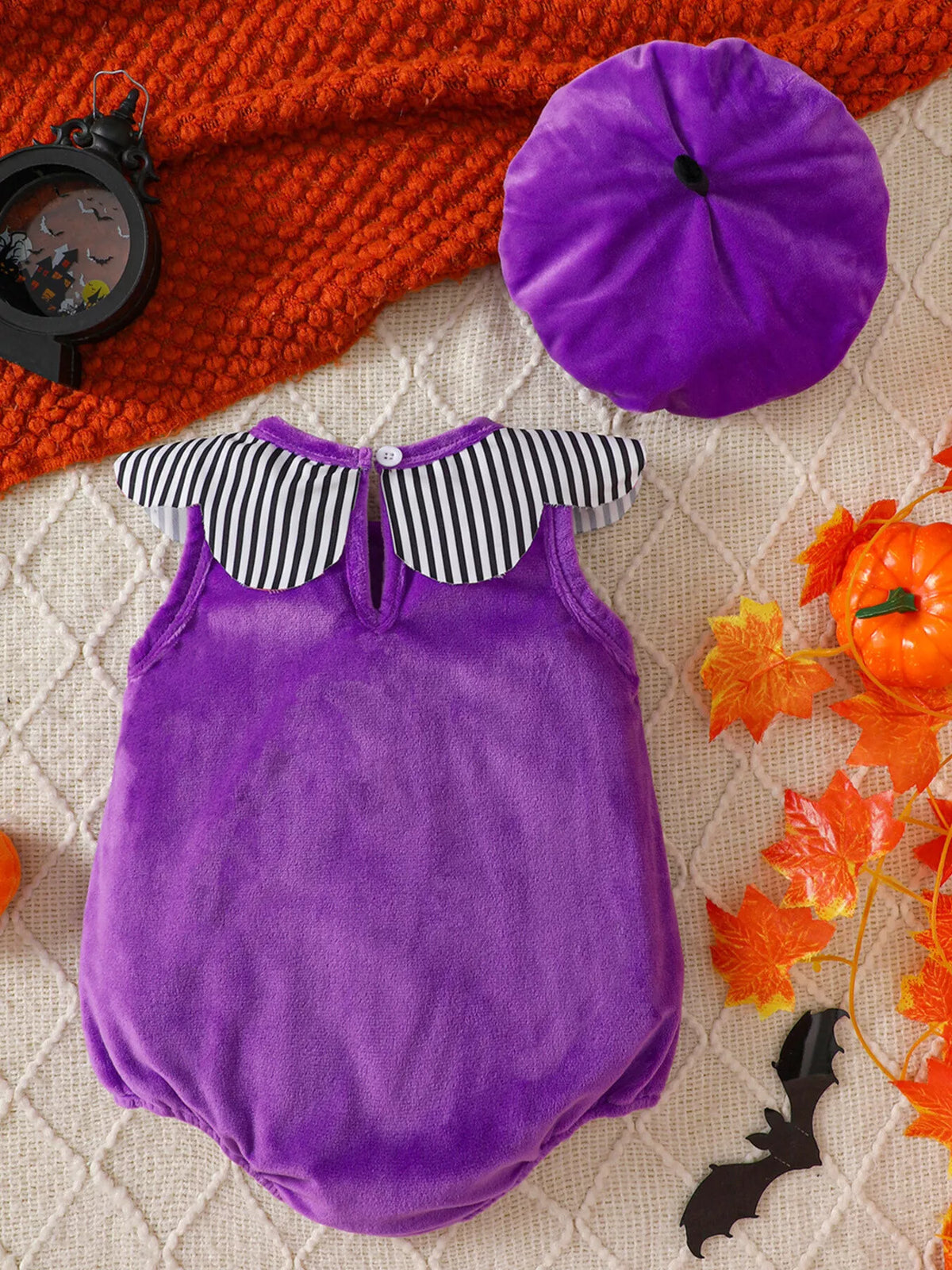 Back of the purple baby bodysuit beside its matching purple hat