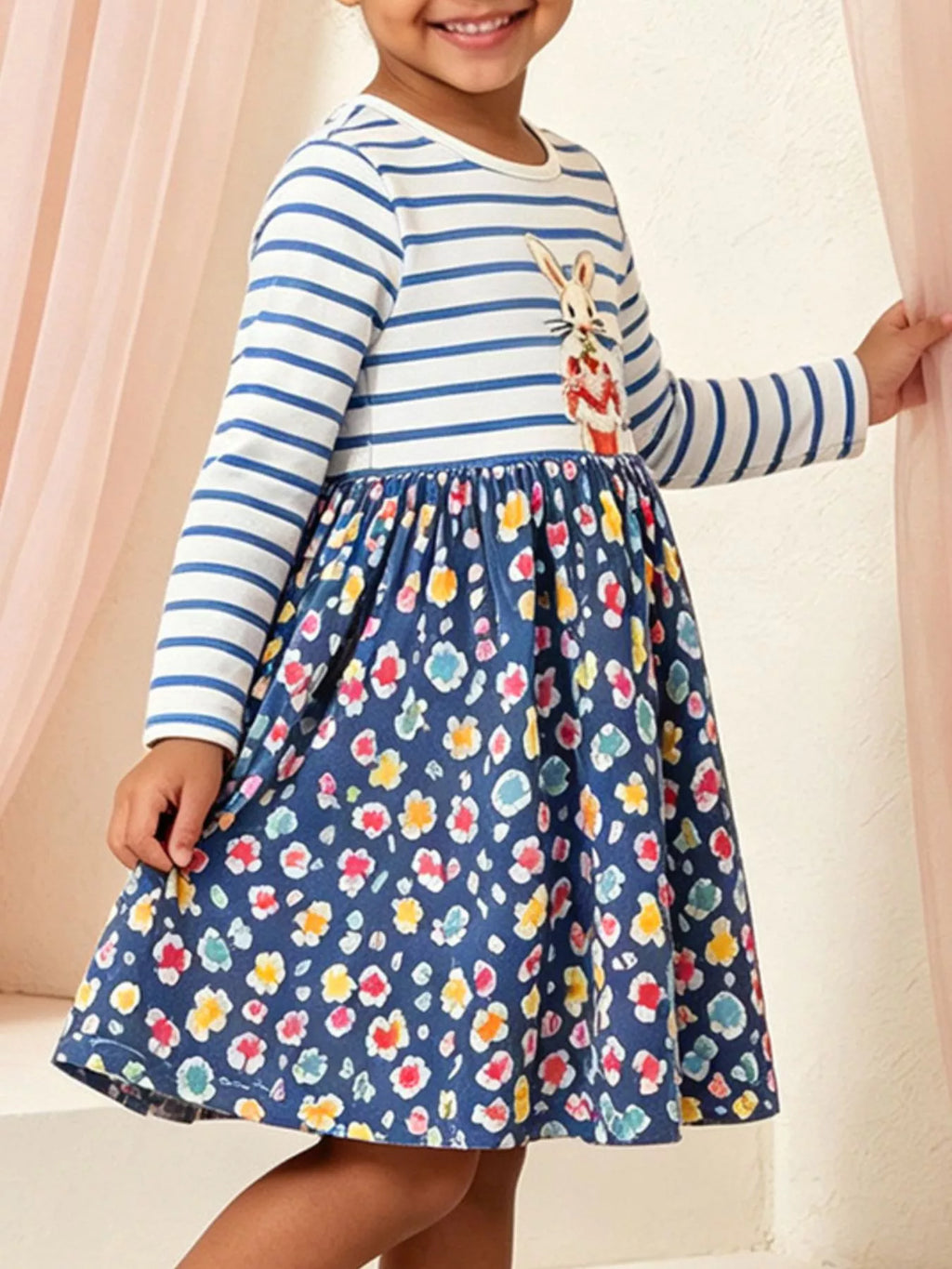 Blue and white striped bunny graphic dress with a dark floral skirt worn by a child