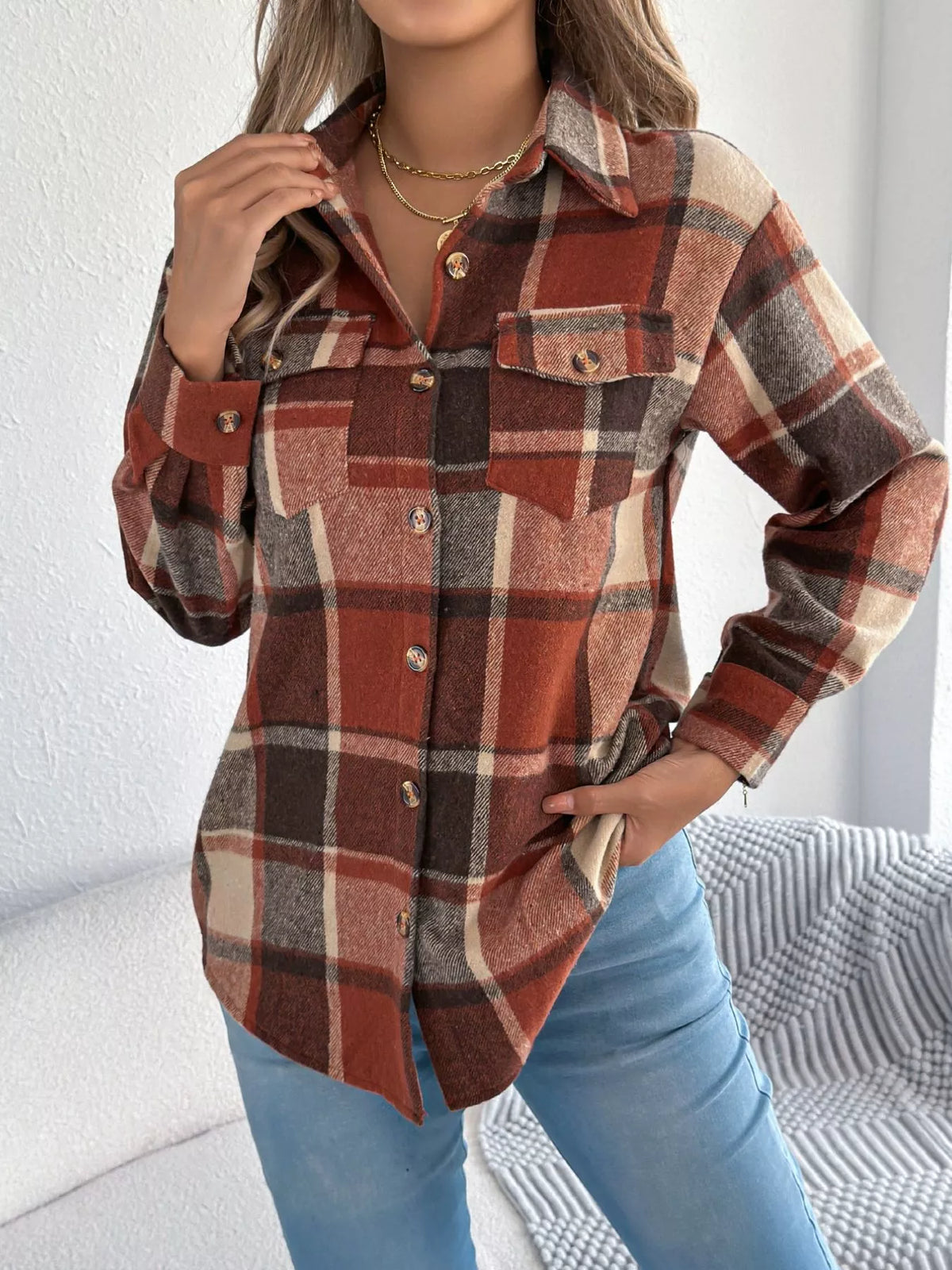 Orange plaid button-down shacket with chest pockets, front view.
