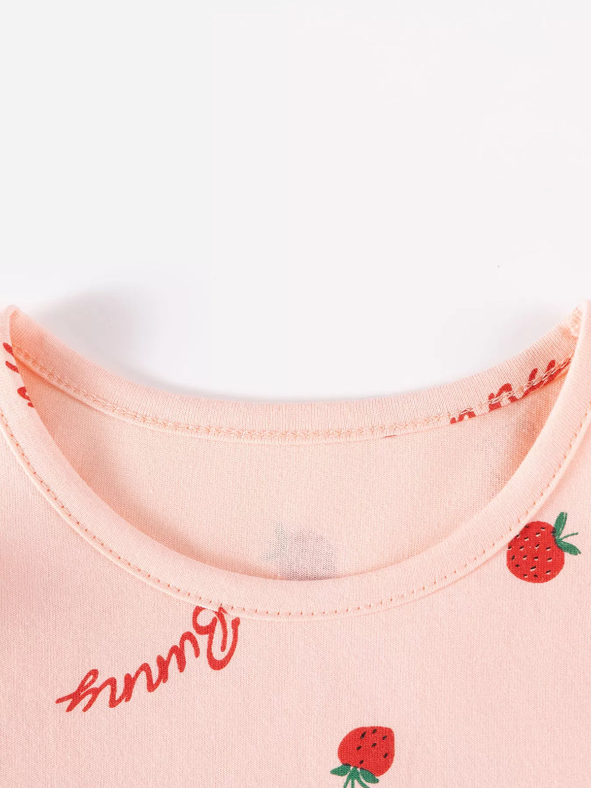 Close-up of the pink dress's crew neckline.