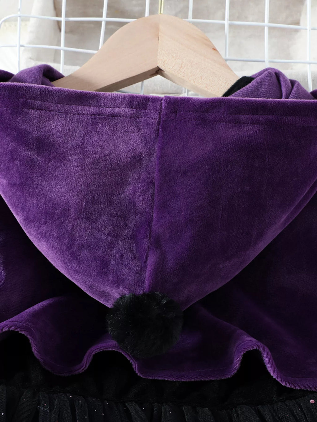 Close-up of the purple cape's hood and scalloped edge.