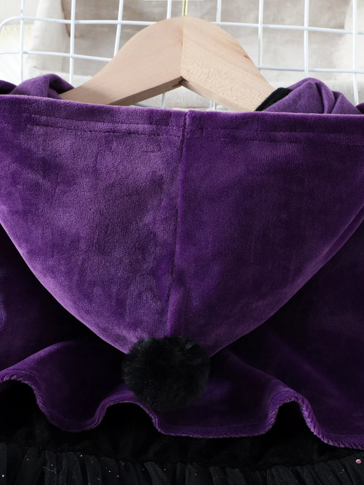 Close-up of the purple cape's hood and scalloped edge.