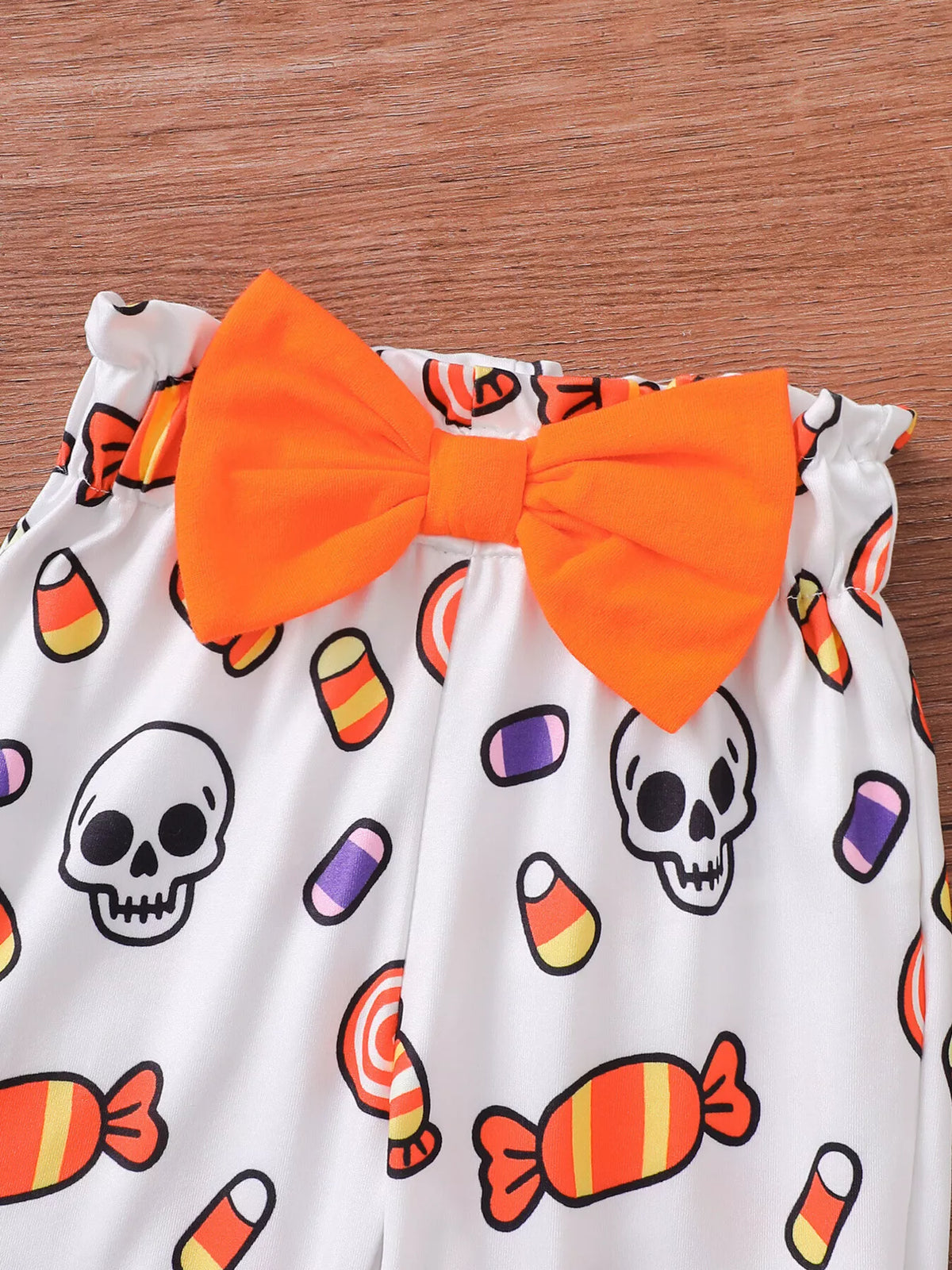 Close-up of the candy-print pants' orange waist bow.