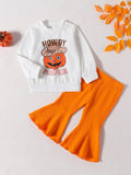 White Howdy Pumpkin children's top paired with orange ribbed flared pants.