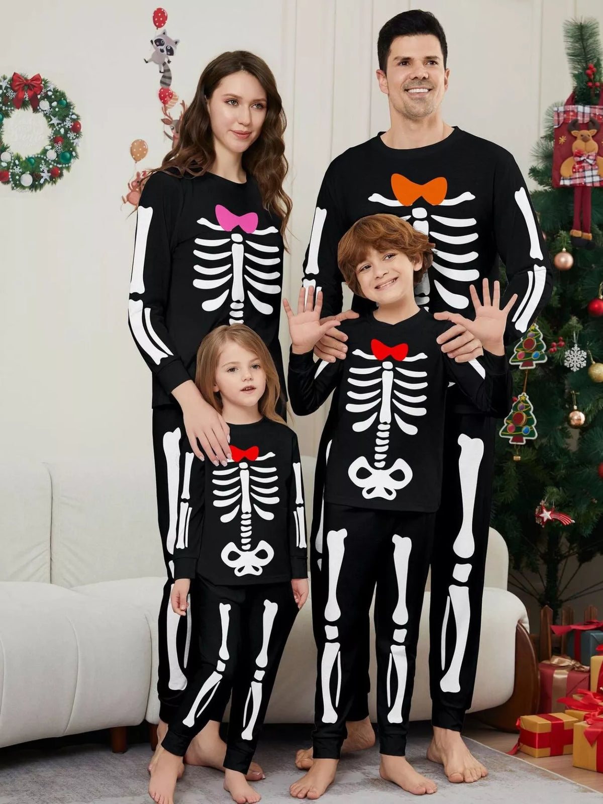 Family wearing black skeleton-print pajamas with colored bow details.