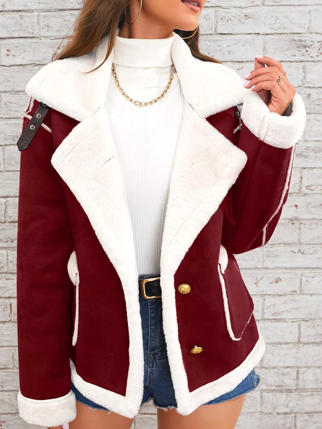 Crimson jacket with wide white plush lapels, contrast trim and front pockets, front view modeled holding the lapel.