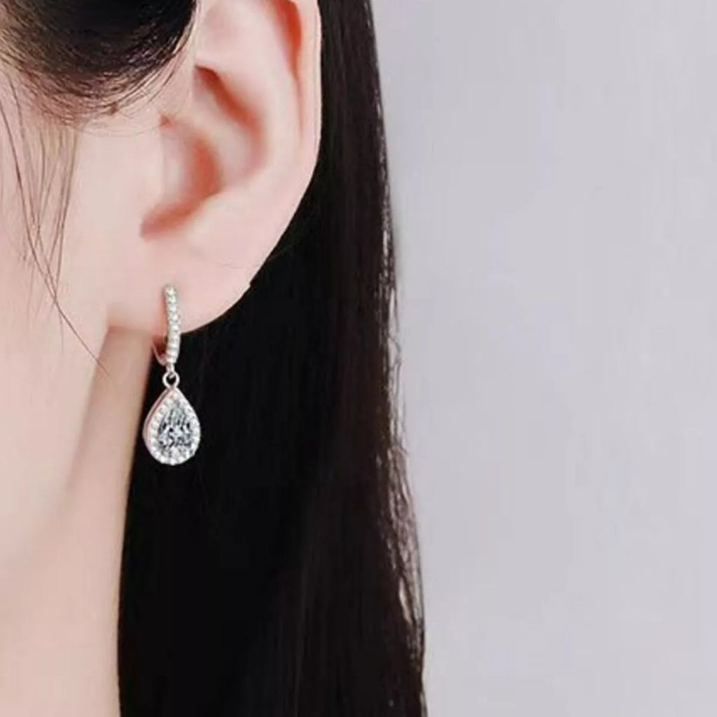 Silver-tone hoop earrings with teardrop halo stone drops — detail view