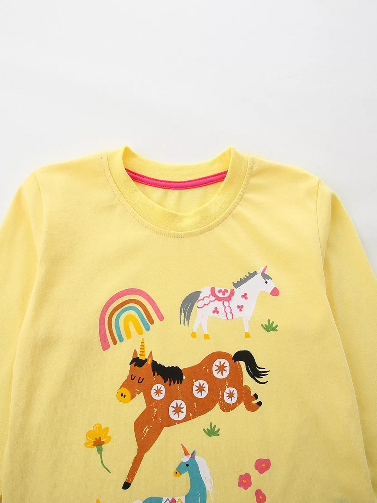 Yellow children’s long-sleeve top with colorful animal and rainbow graphics