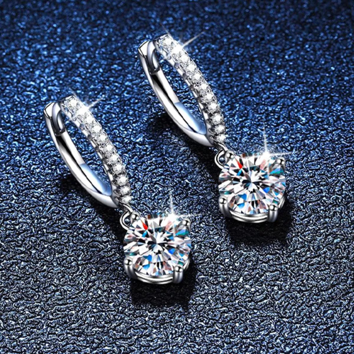 Silver-tone hoop earrings with round halo stone drops — detail view