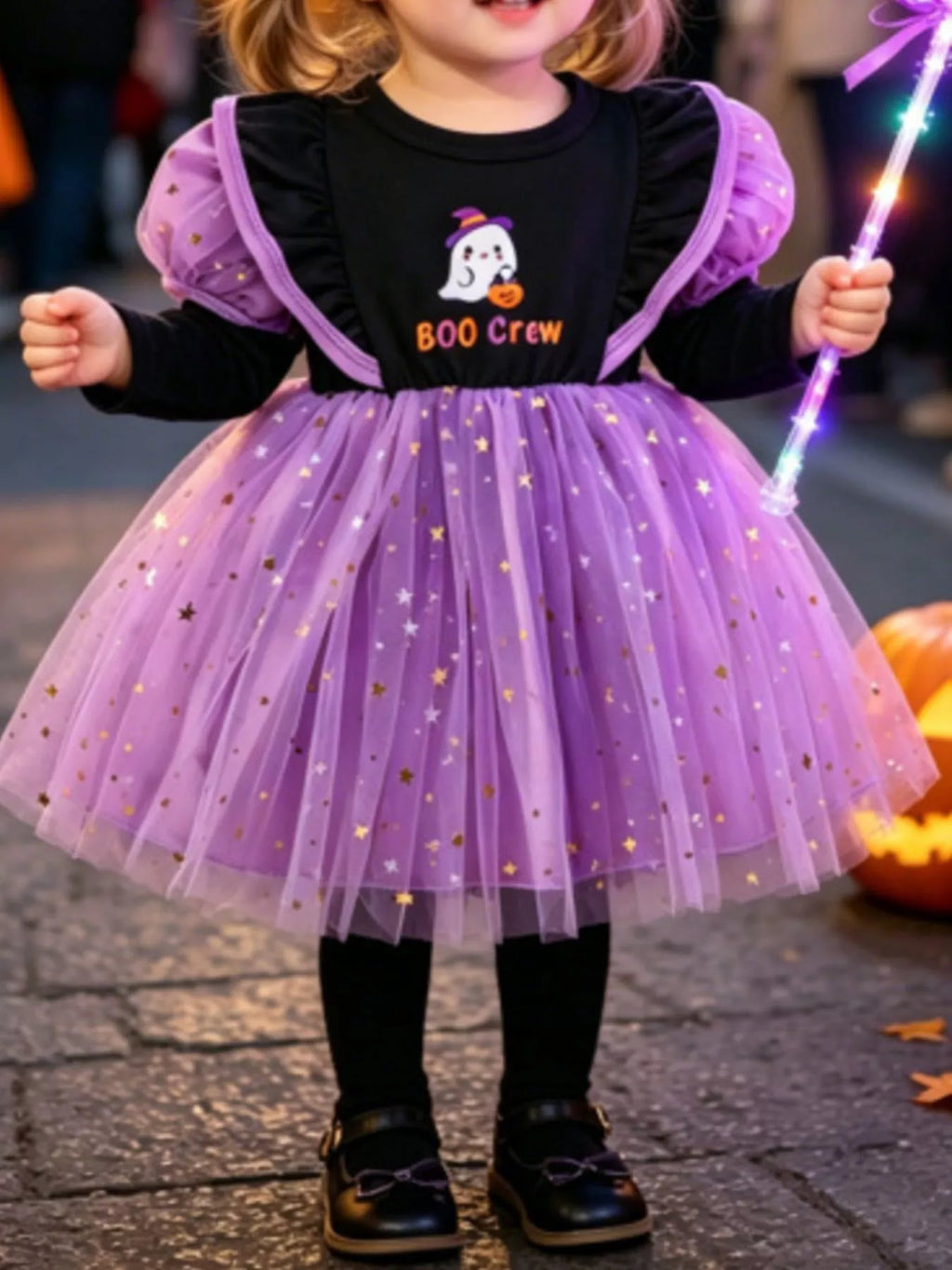 Child wearing a black Boo Crew bodice with purple puff sleeves and starry purple tulle skirt.