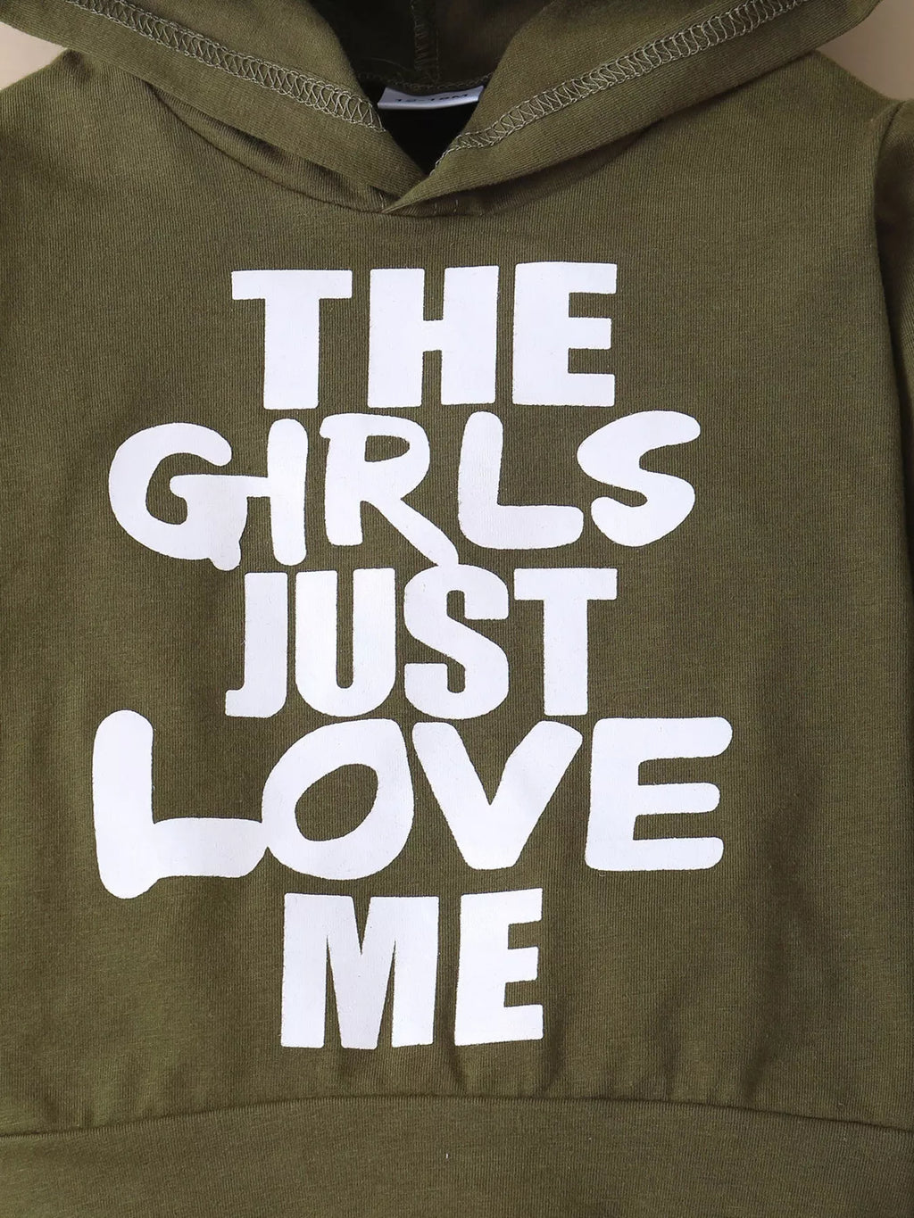 THE GIRLS JUST LOVE ME lettering on the olive hoodie