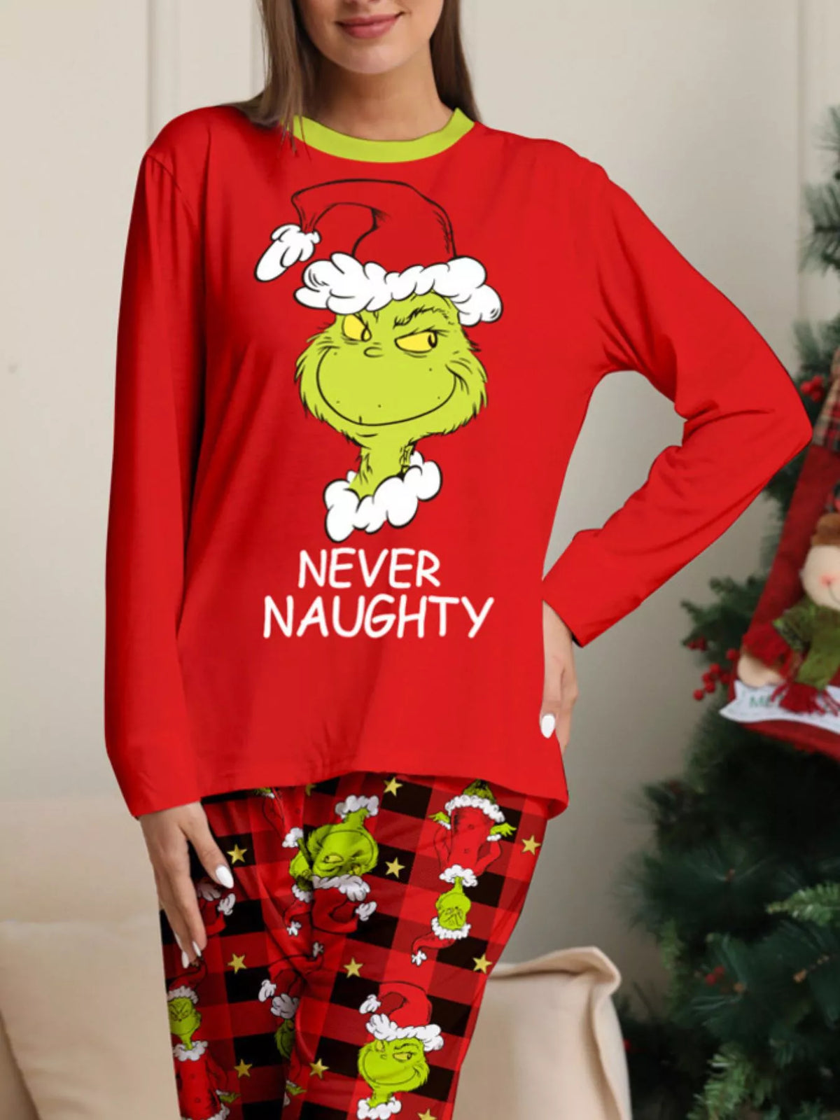 Grinch face graphic and NEVER NAUGHTY lettering on the red pajama top