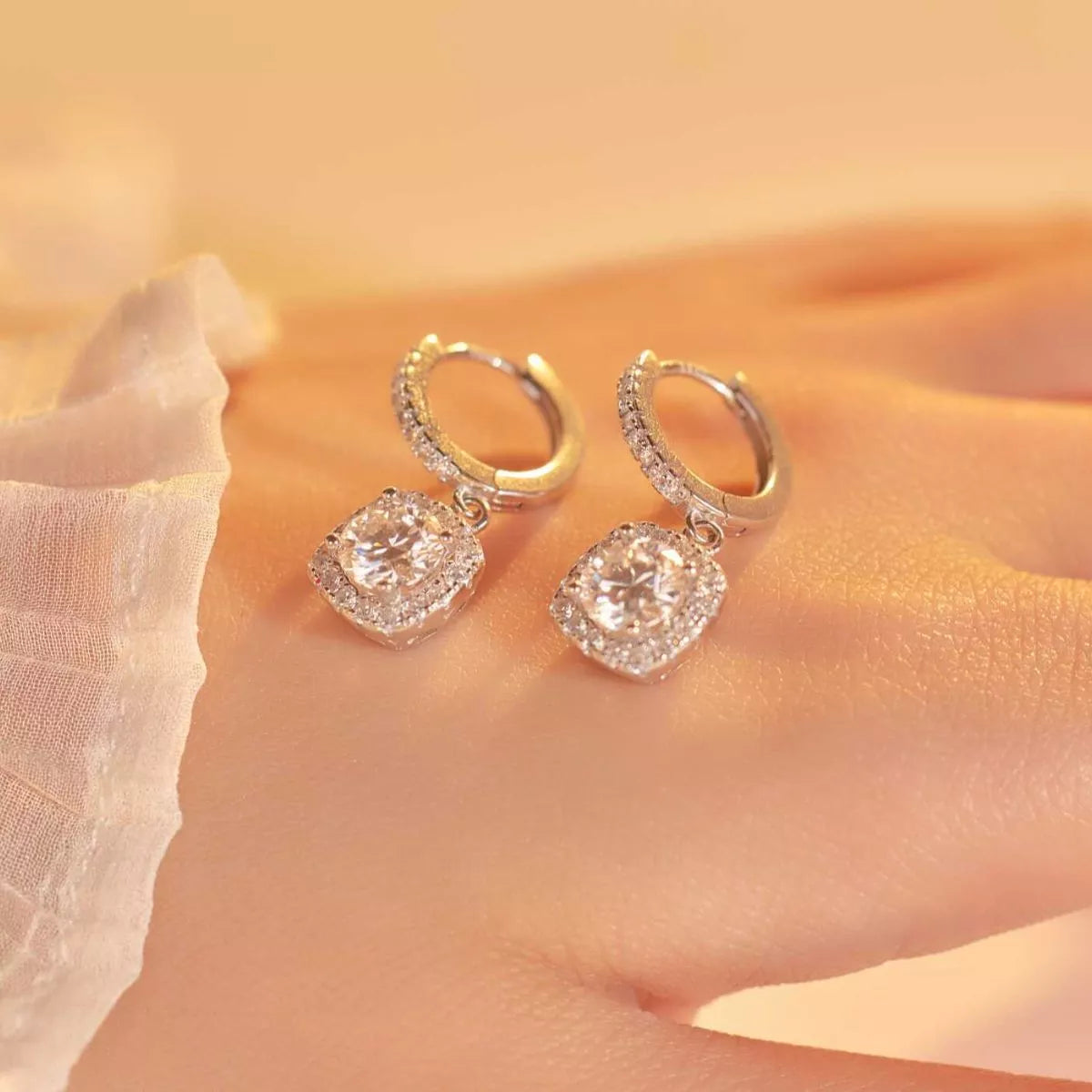 Silver-tone hoop earrings with square halo stone drops — detail view