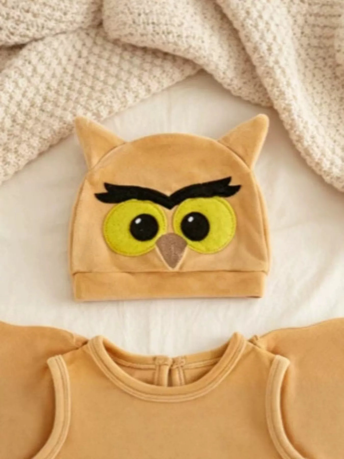 Mustard owl hat with embroidered eyes and pointed ears