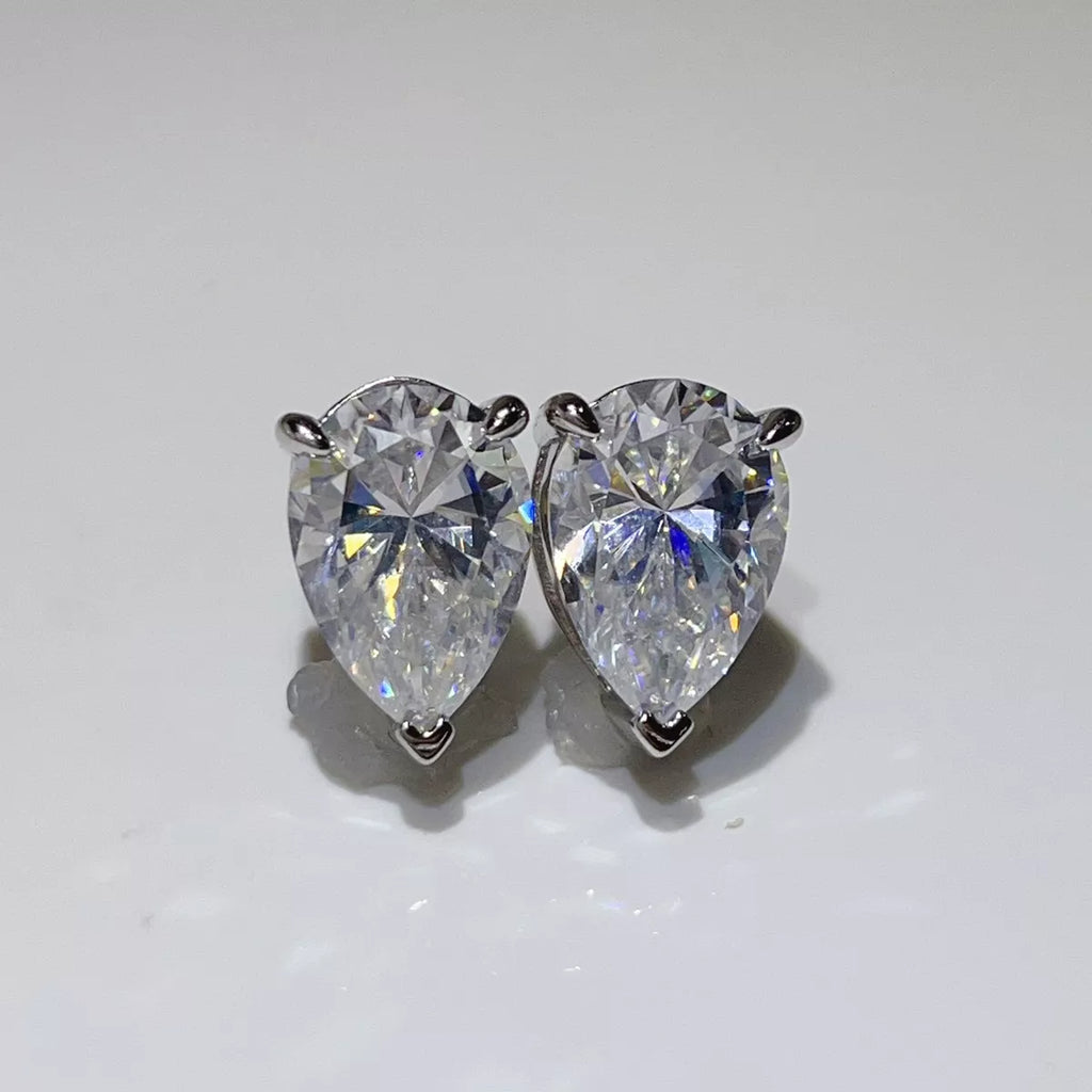Silver-tone stud earrings with triangular clear stones — detail view