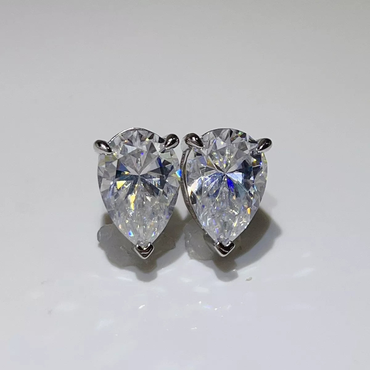 Silver-tone stud earrings with triangular clear stones — detail view