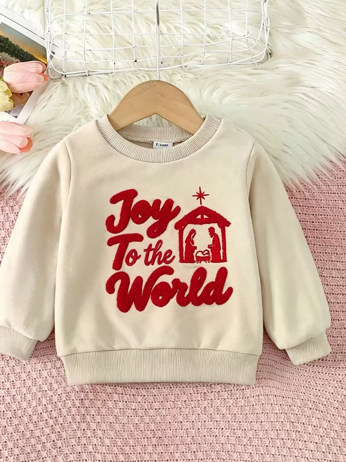Cream children's sweatshirt with red Joy to the World lettering and a nativity graphic.